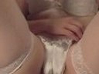 Private home video with lecherous babe dressed in sexy white lingerie and stockings pulls her panties aside and has hard clit wildly rubbed.